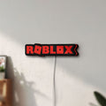 Unlit Roblox LED lightbox mounted on a wall in daylight
