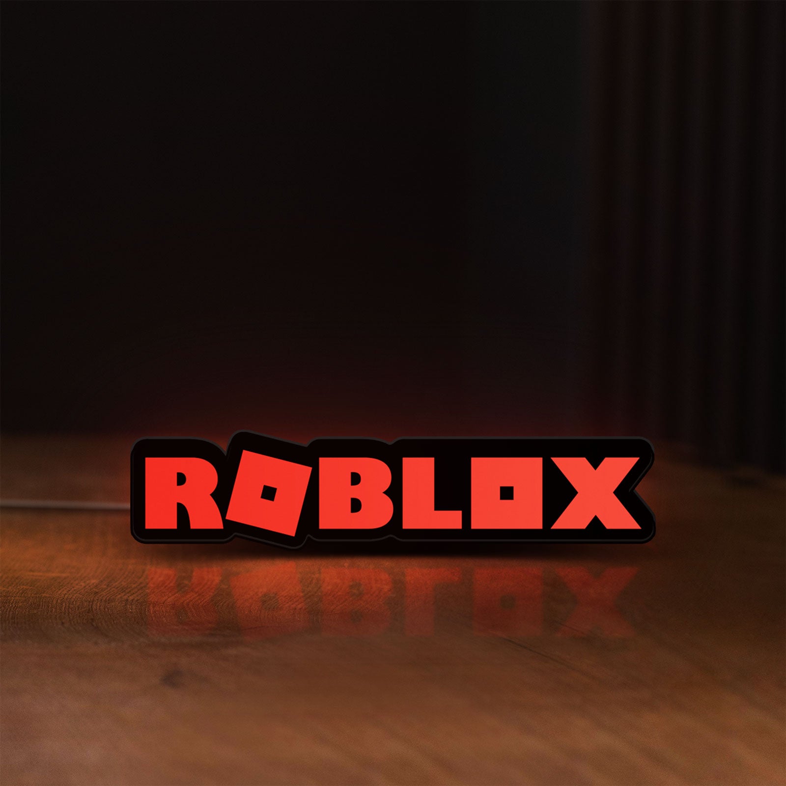 Front view of Roblox LED lightbox sign glowing on a wooden desk