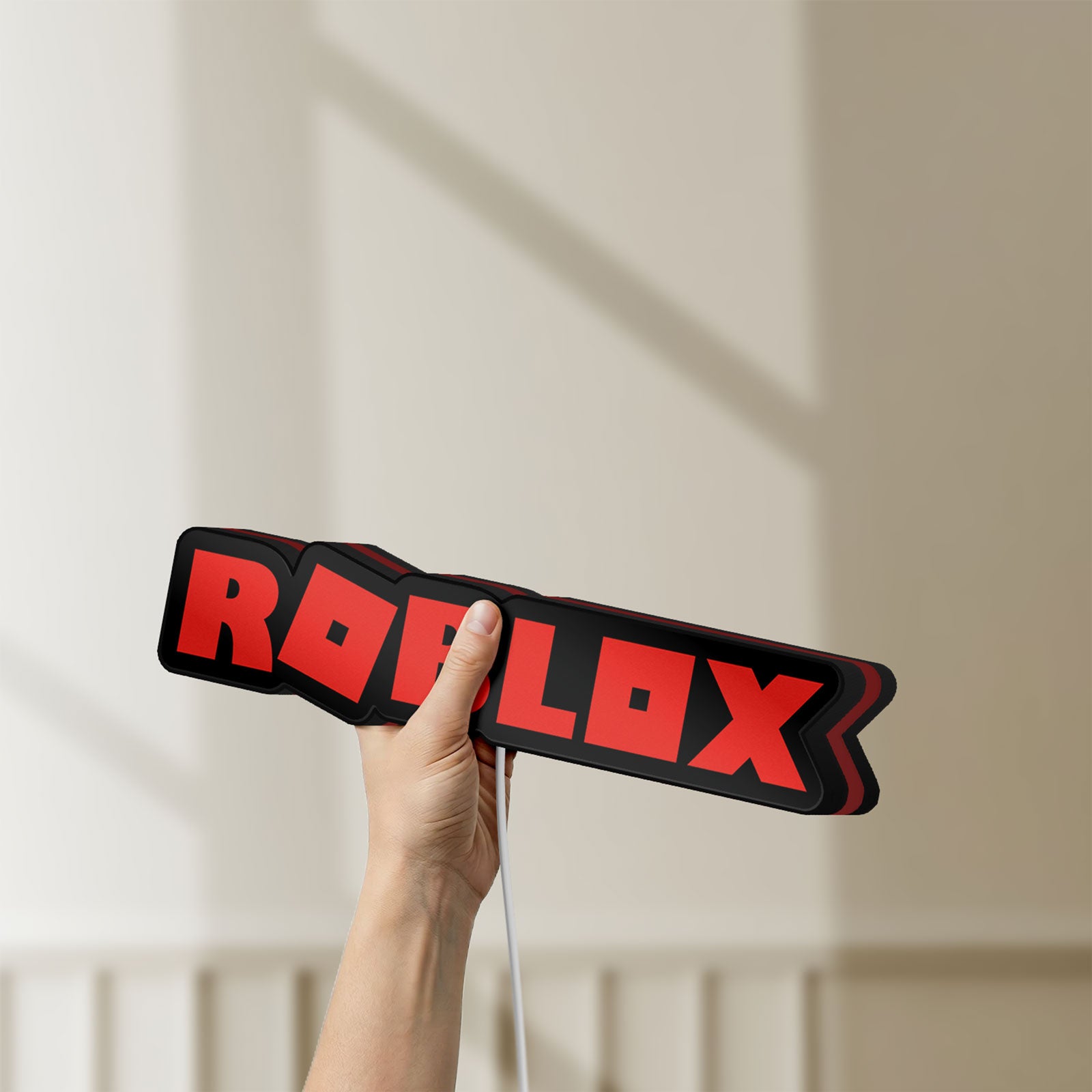 Unlit Roblox LED lightbox held by hand to show size and details