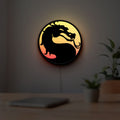 Mortal Kombat LED lightbox hanging on a room wall with soft yellow light