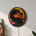 Unlit Mortal Kombat LED lightbox mounted on a wall in daylight