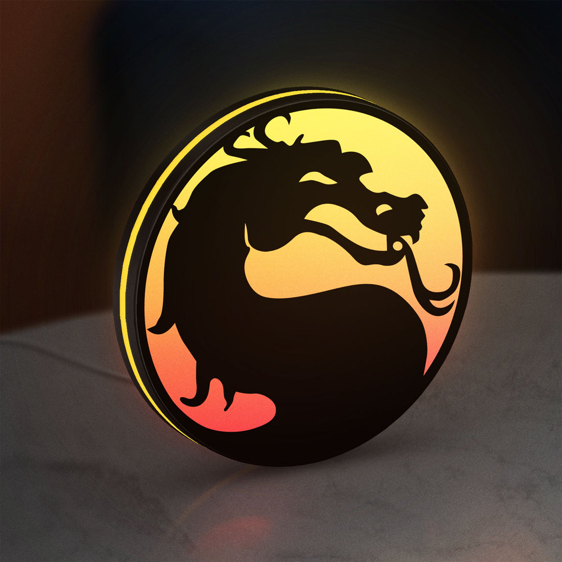 Mortal Kombat LED lightbox hanging on a wall with yellow glow