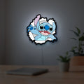 Stitch LED lightbox hanging on a room wall with soft white light