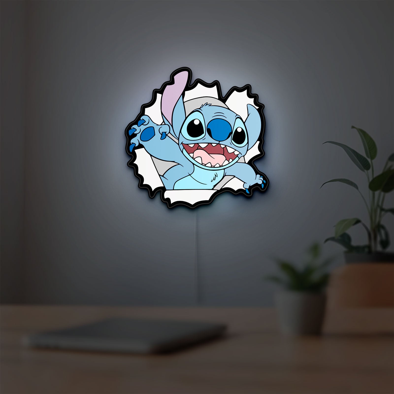 Stitch LED lightbox hanging on a room wall with soft white light