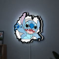 Stitch LED lightbox hanging on a wall with white glow