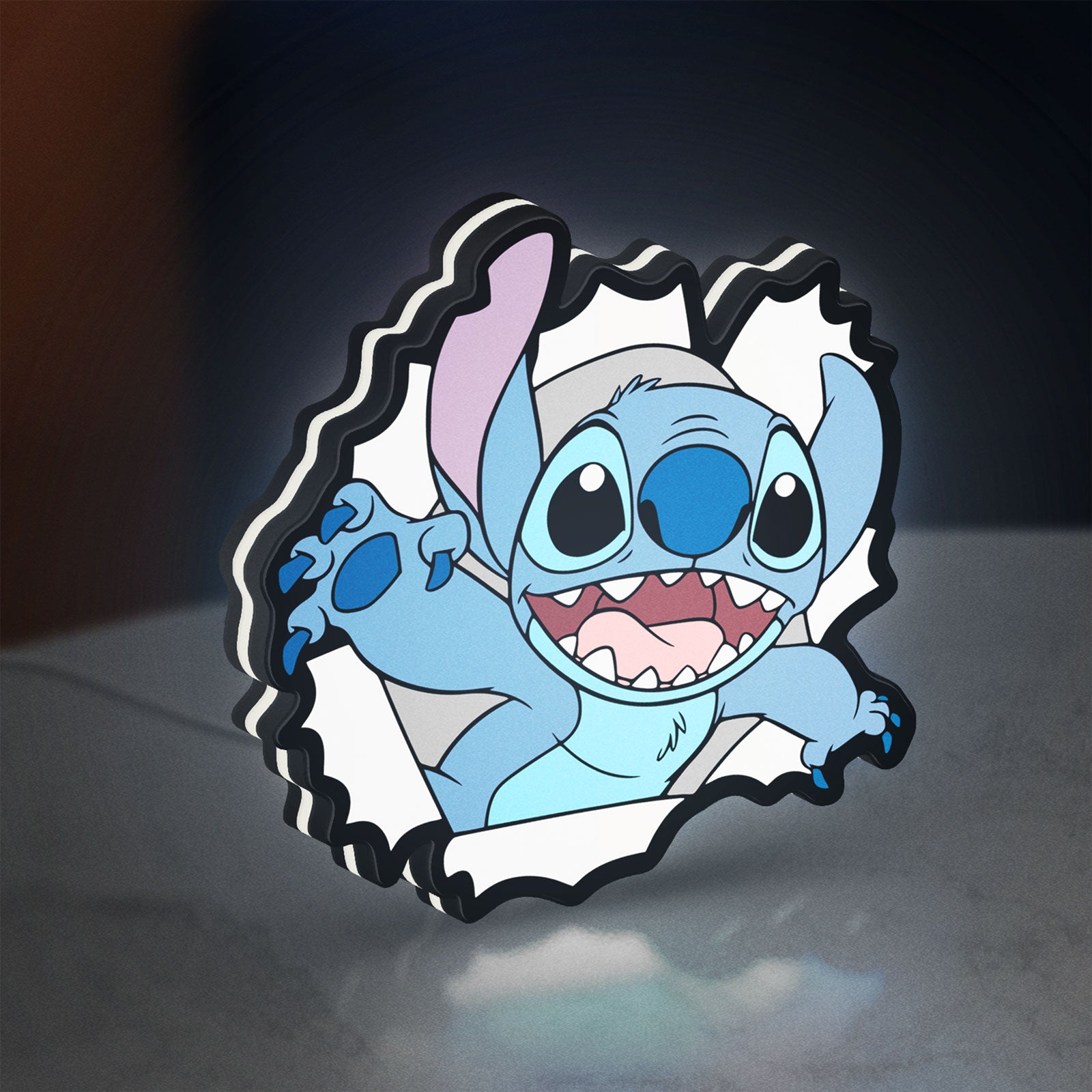 Stitch LED lightbox standing on a desk from an angled side view with white glow