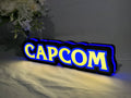 Illuminated angled view standing of Capcom Illuminated Sign in 30cm, unique wall art for desk and room decor