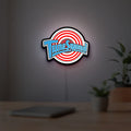 TuneSquad LED lightbox hanging on a room wall with soft white light