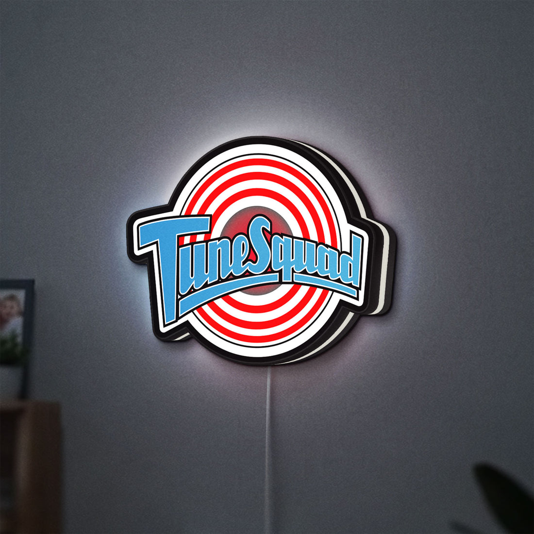 TuneSquad LED lightbox hanging on a wall with white glow