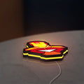 Iron Man LED lightbox lying flat on a desk with yellow glow