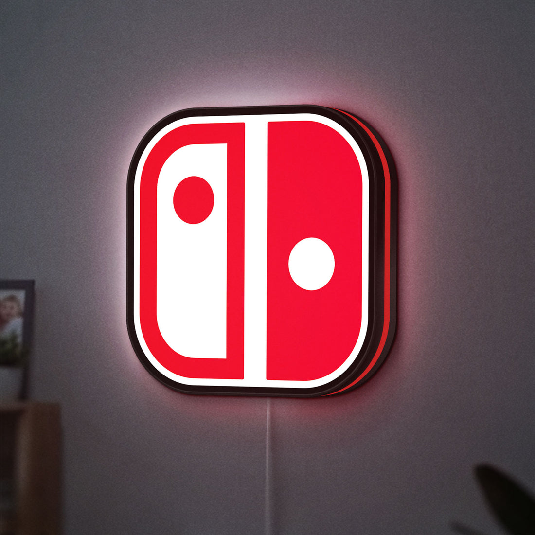 Nintendo Switch LED lightbox hanging on a wall with red glow
