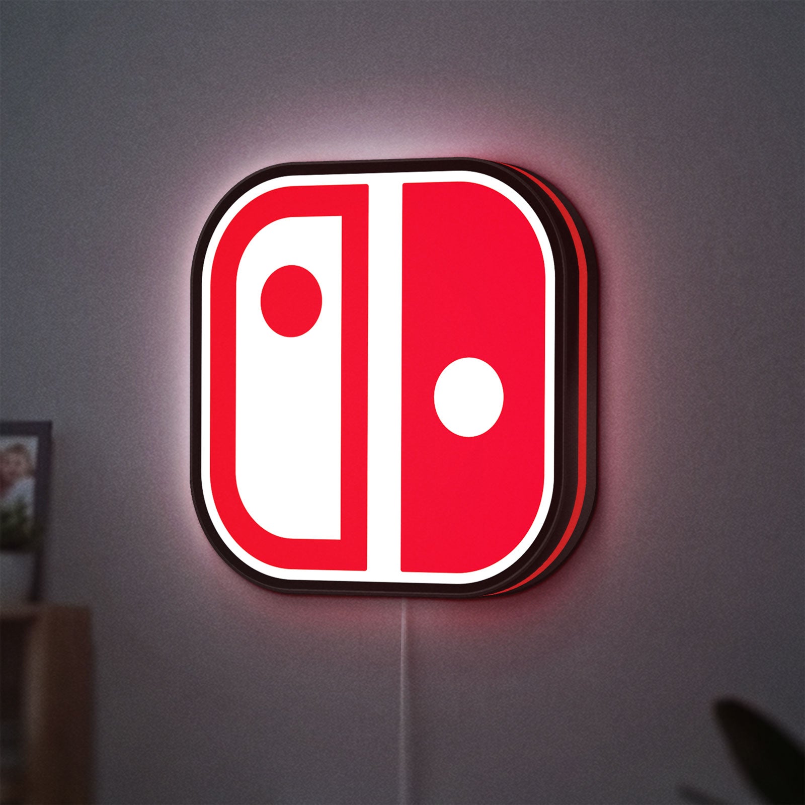 Nintendo Switch LED lightbox hanging on a wall with red glow
