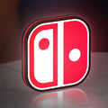 Nintendo Switch LED lightbox standing on a desk from an angled side view with red glow