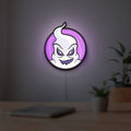 Club Misterio LED lightbox hanging on a room wall with soft purple light