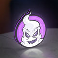Club Misterio LED lightbox standing on a desk from an angled side view with purple glow