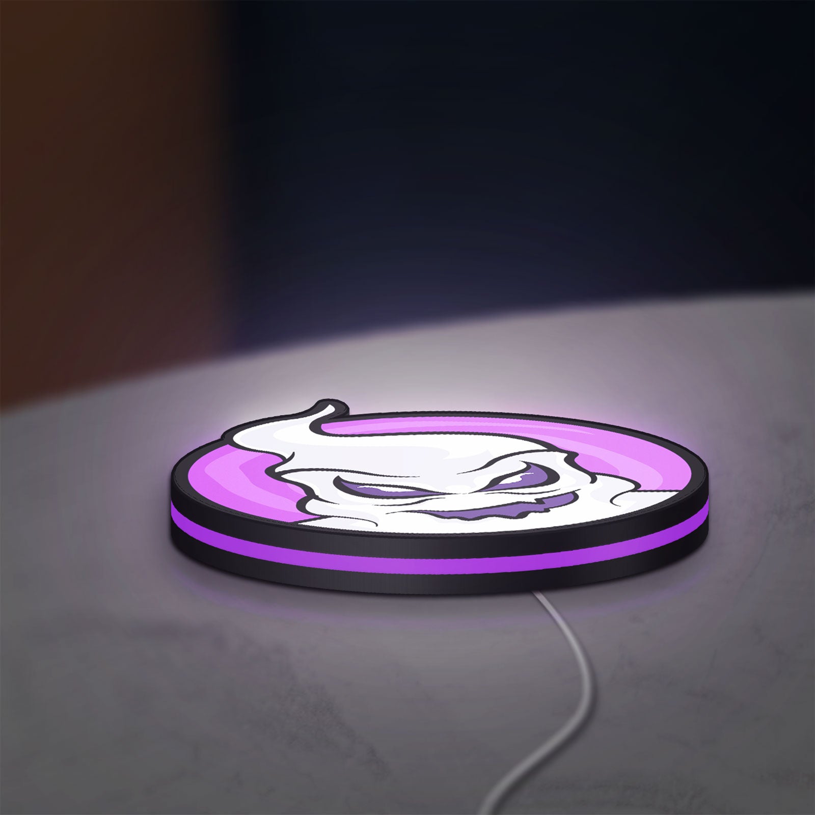 Club Misterio LED lightbox lying flat on a desk with purple glow