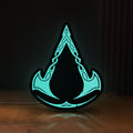Front view of Assassins Creed Valhalla LED lightbox sign glowing on a wooden desk