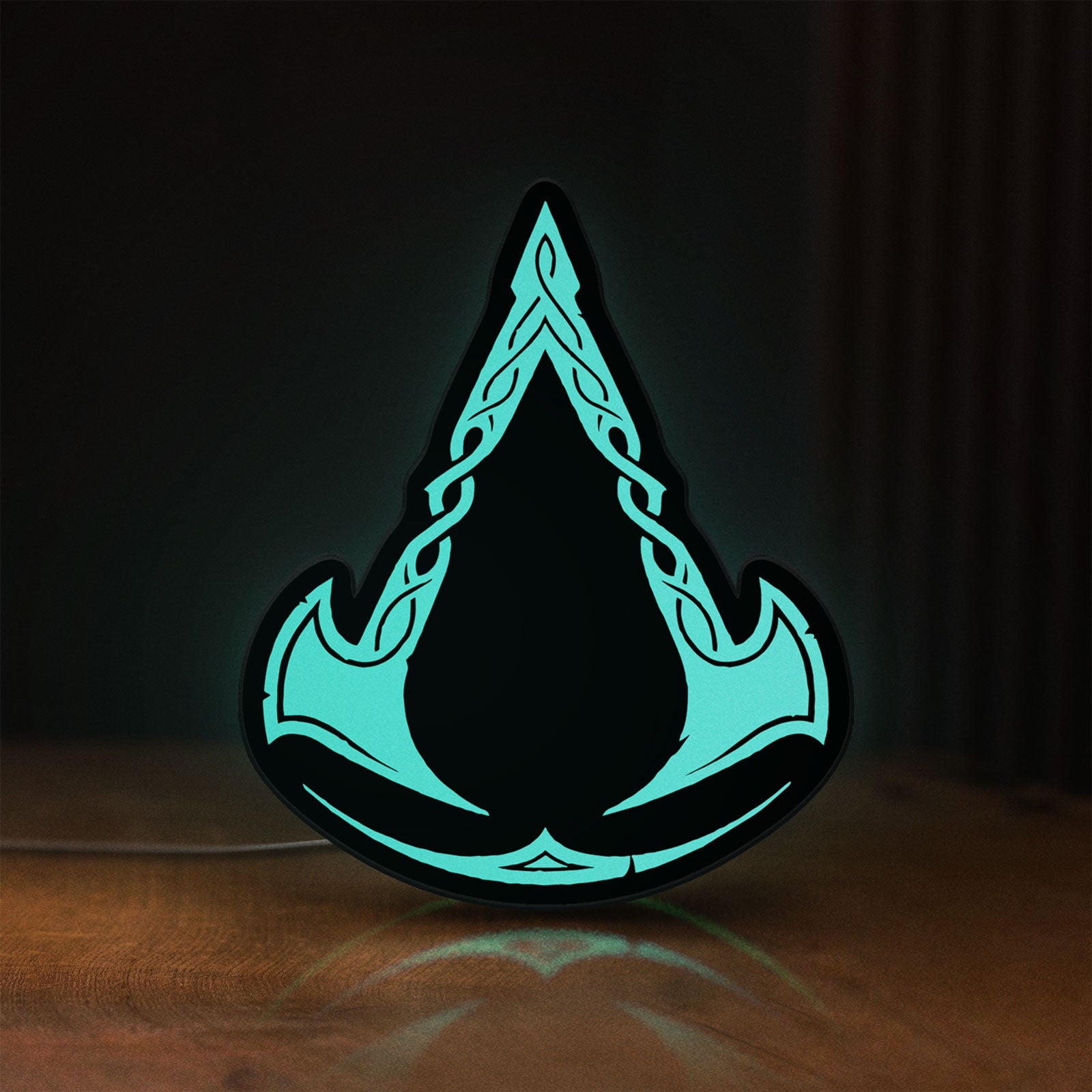 Front view of Assassins Creed Valhalla LED lightbox sign glowing on a wooden desk