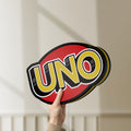 Unlit UNO Wild Draw Four LED lightbox held by hand to show size and details