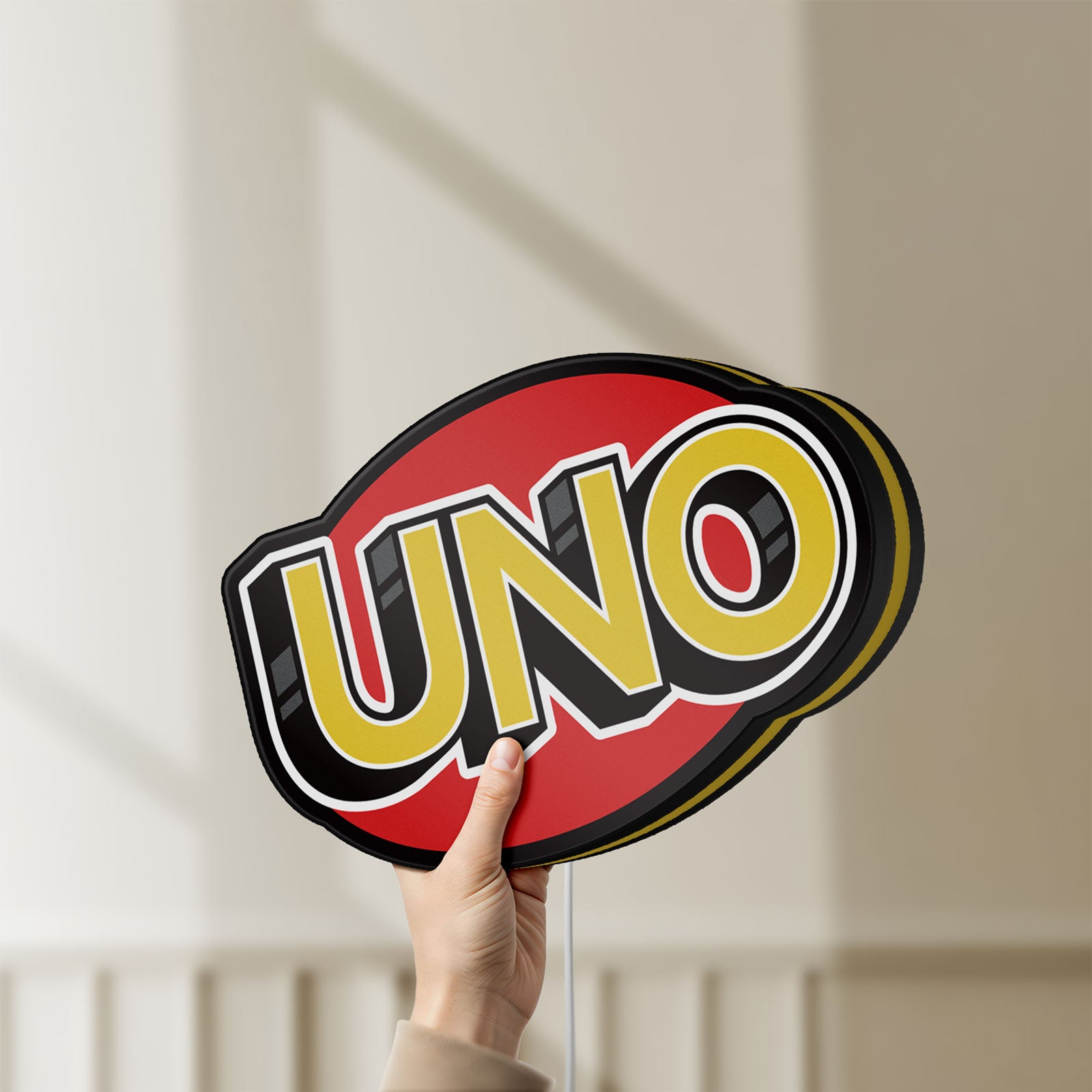 Unlit UNO Wild Draw Four LED lightbox held by hand to show size and details