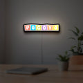 Pocoyo LED lightbox hanging on a room wall with soft white light