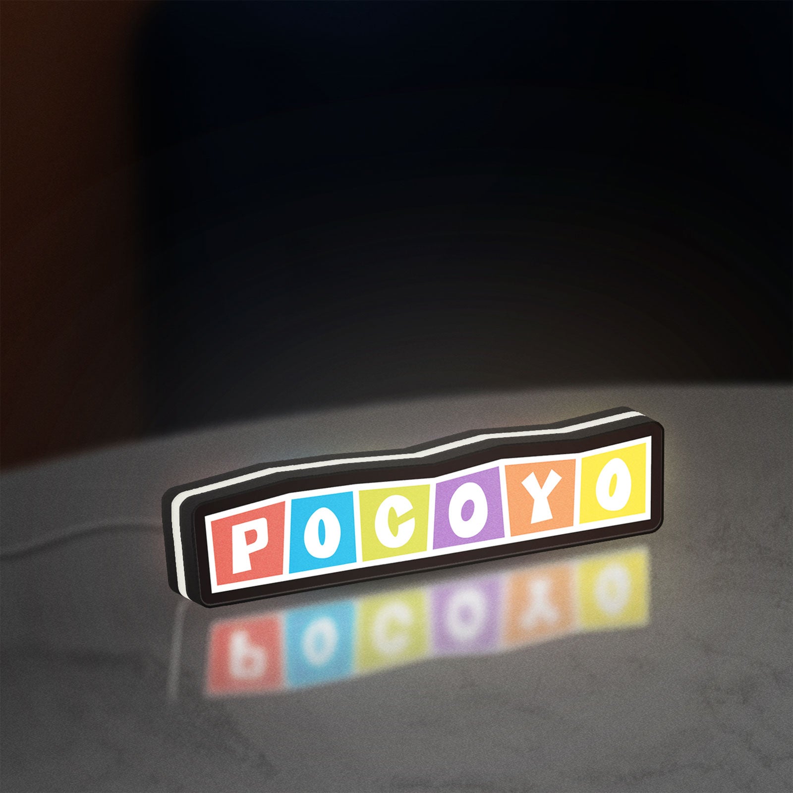 Pocoyo LED lightbox standing on a desk from an angled side view with white glow