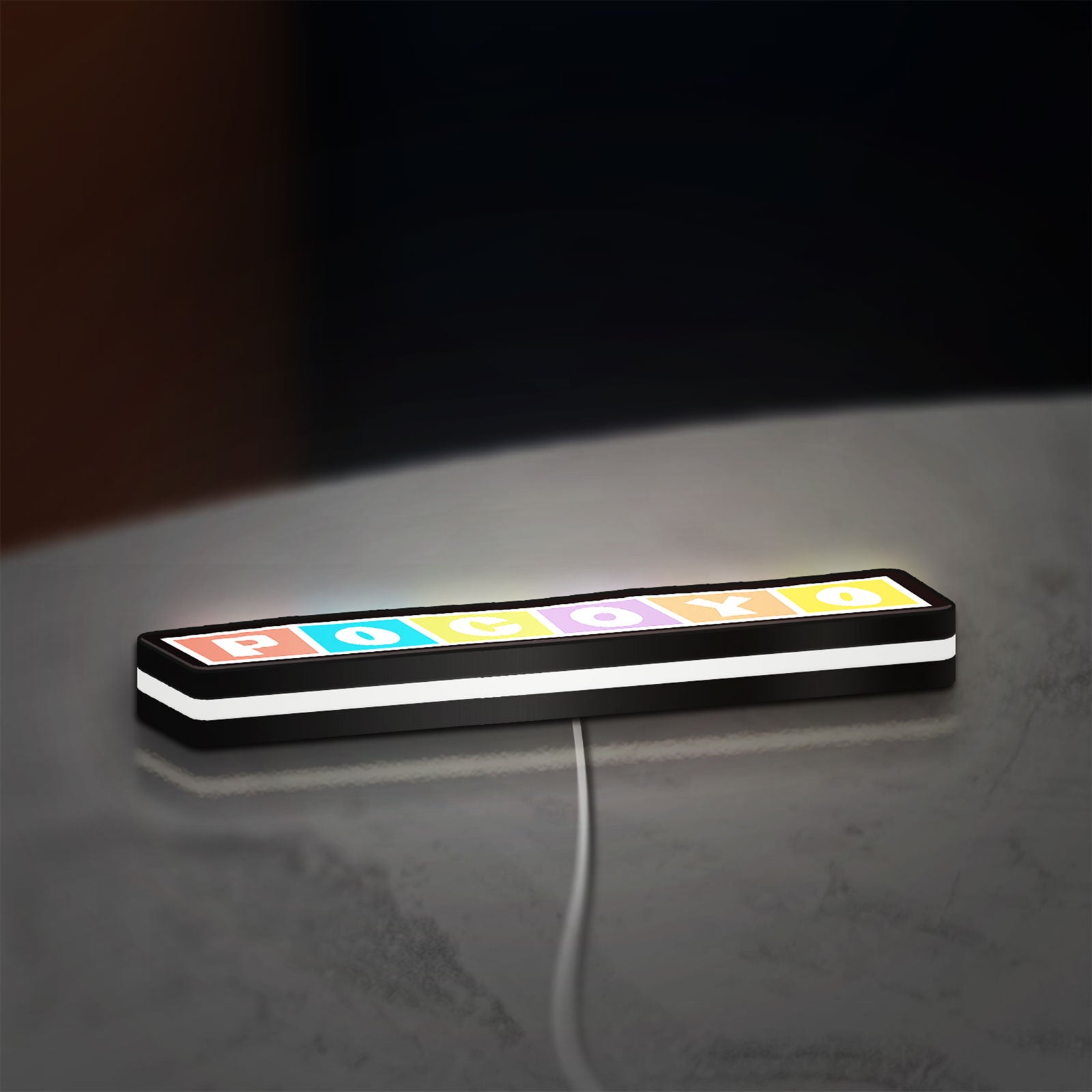 Pocoyo LED lightbox lying flat on a desk with white glow
