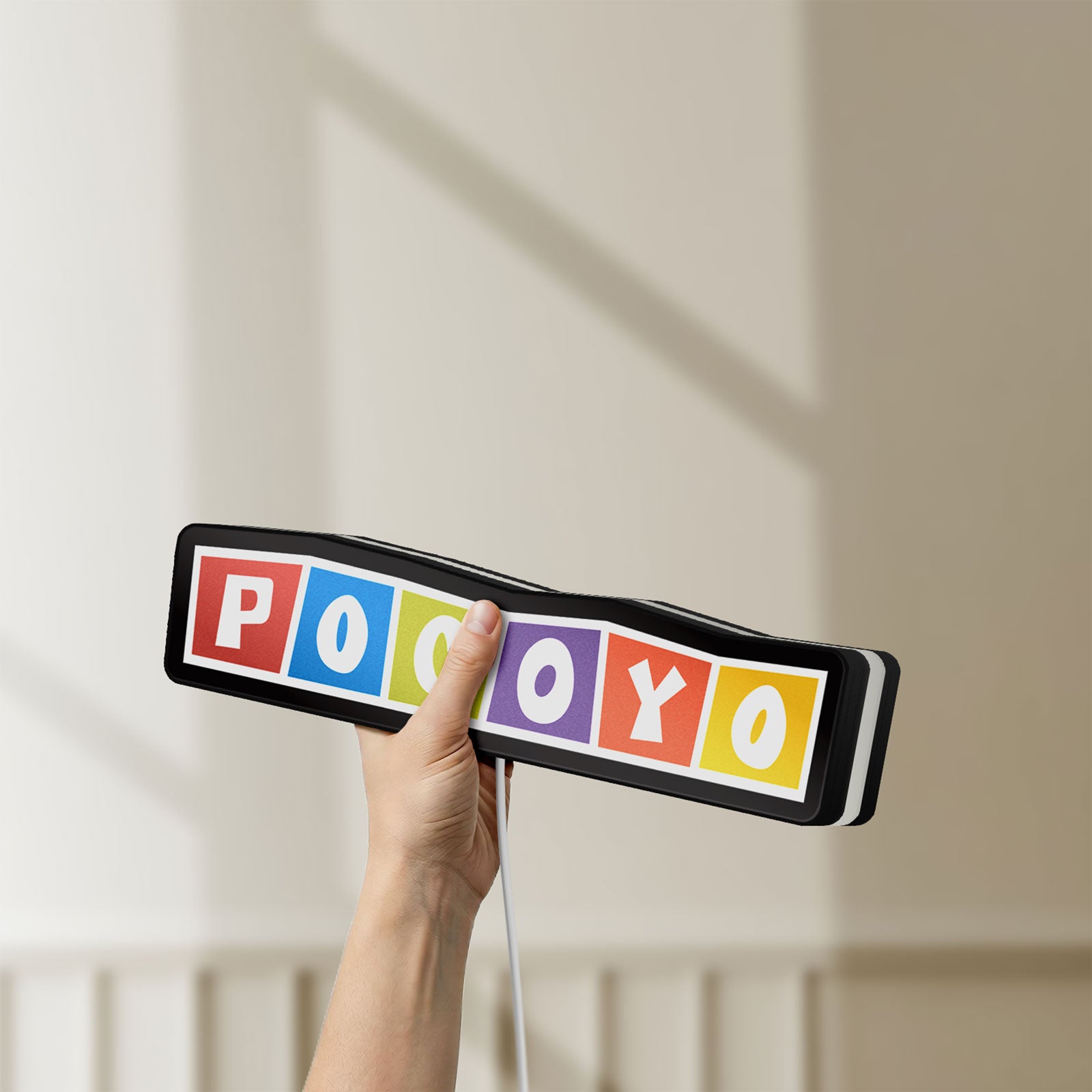 Unlit Pocoyo LED lightbox held by hand to show size and details