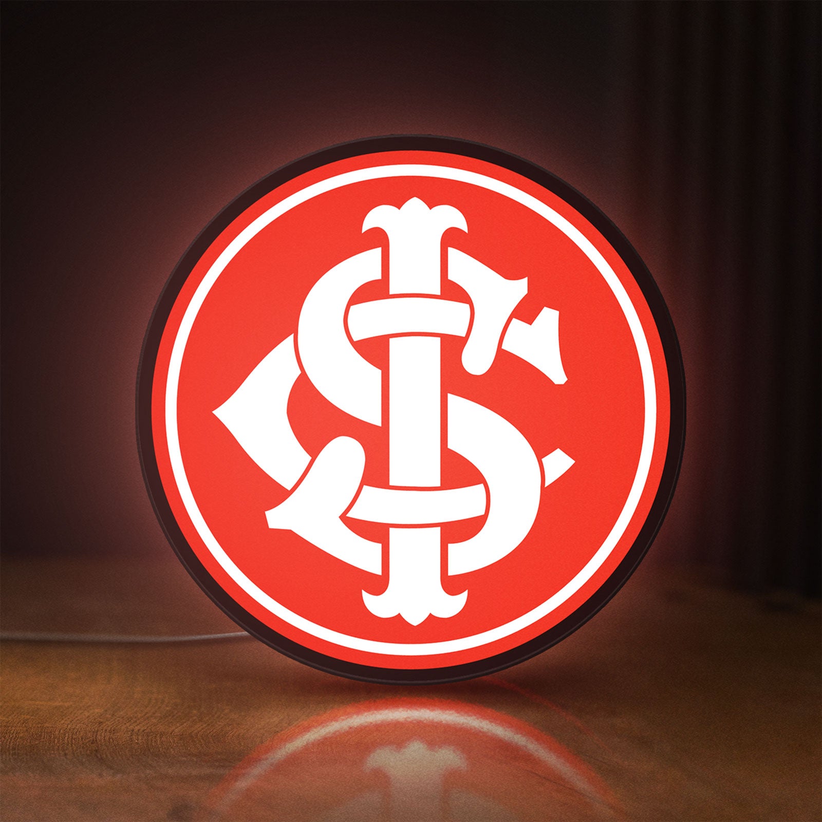 Front view of Sport Club Internacional 6 Estrelas LED lightbox sign glowing on a wooden desk