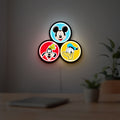 MICKEY DONALD GOOFIE LED lightbox hanging on a room wall with soft yellow light