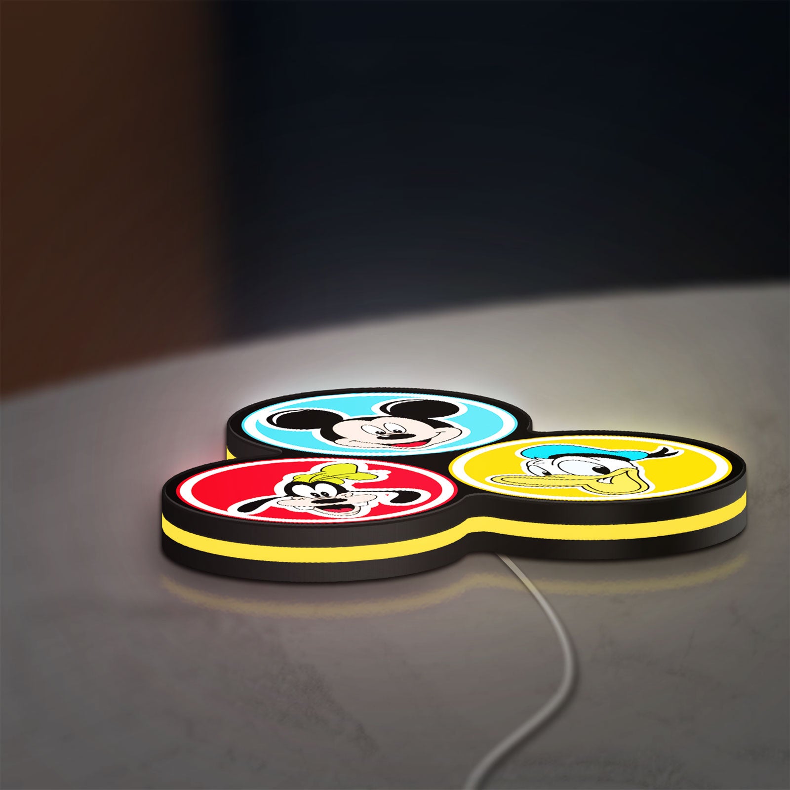 MICKEY DONALD GOOFIE LED lightbox lying flat on a desk with yellow glow