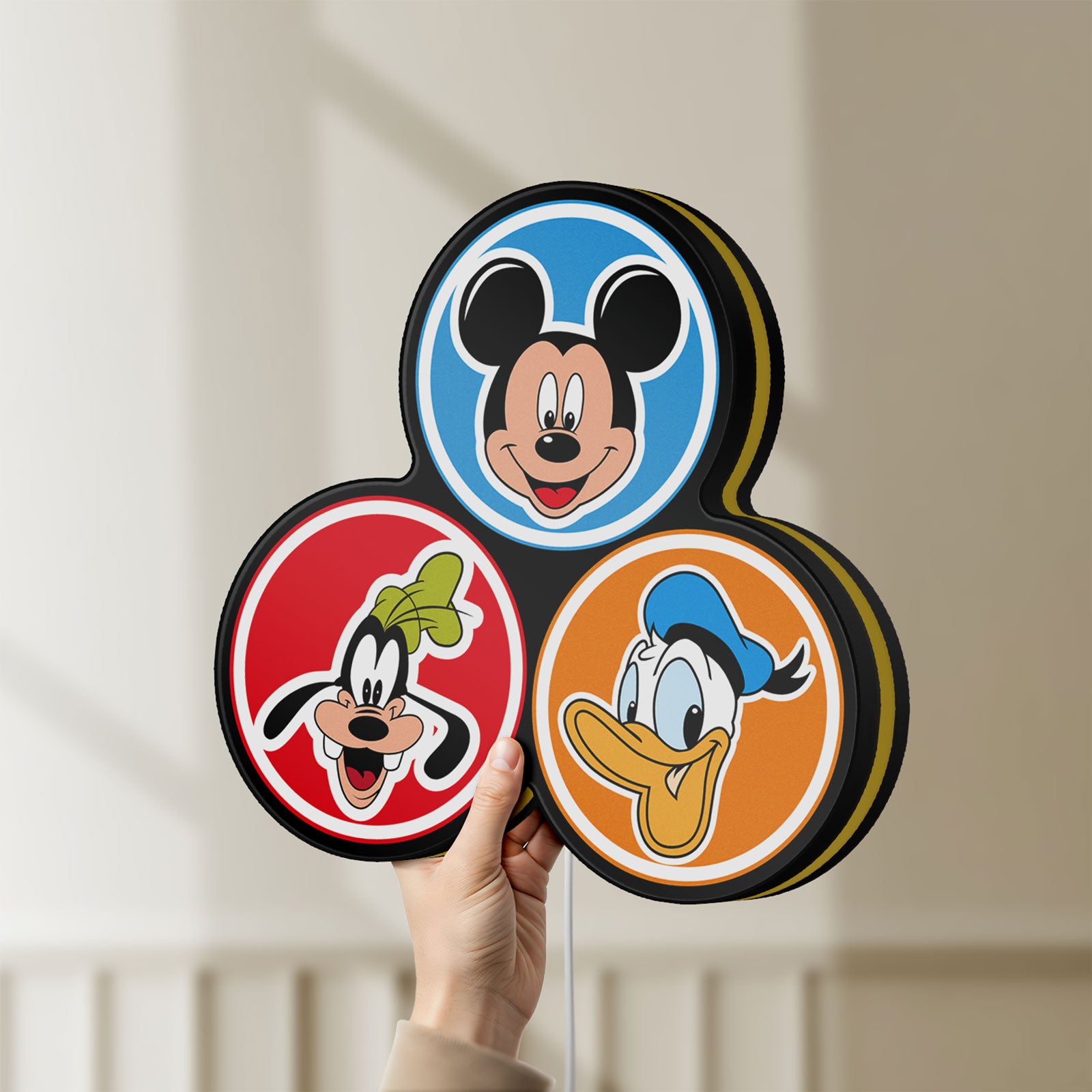 Unlit MICKEY DONALD GOOFIE LED lightbox held by hand to show size and details