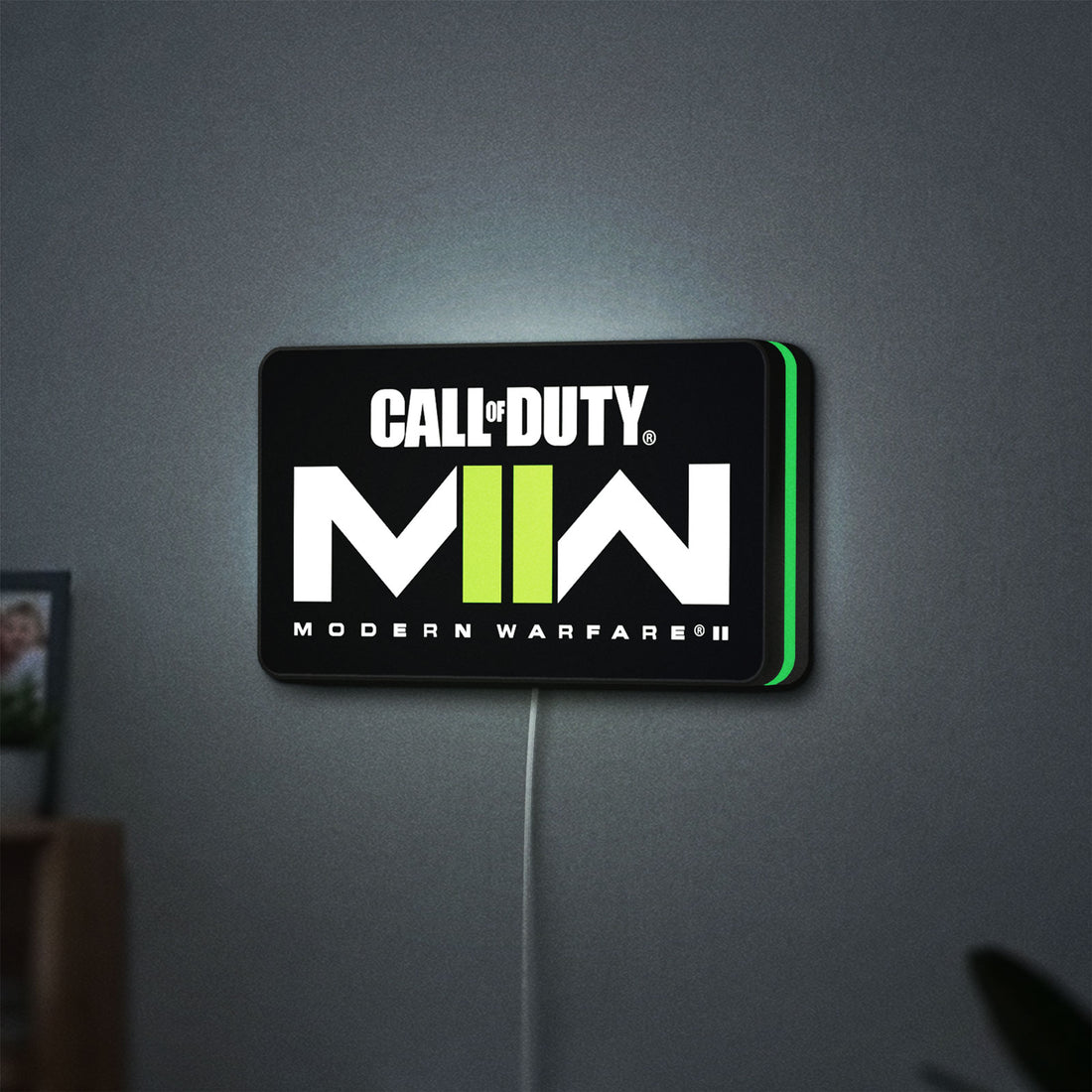 Call of Duty Modern Warfare II LED lightbox hanging on a wall with green glow