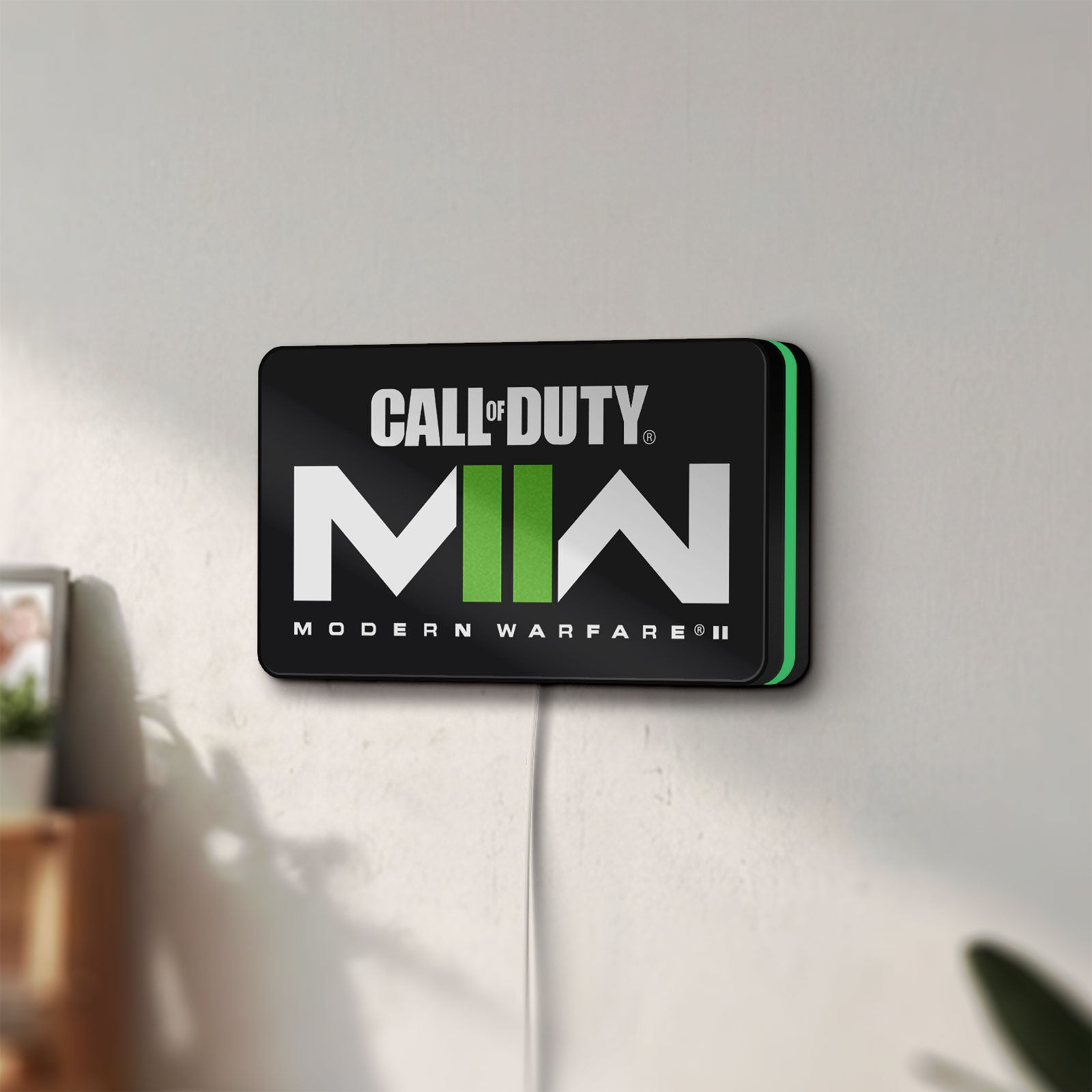 Unlit Call of Duty Modern Warfare II LED lightbox mounted on a wall in daylight