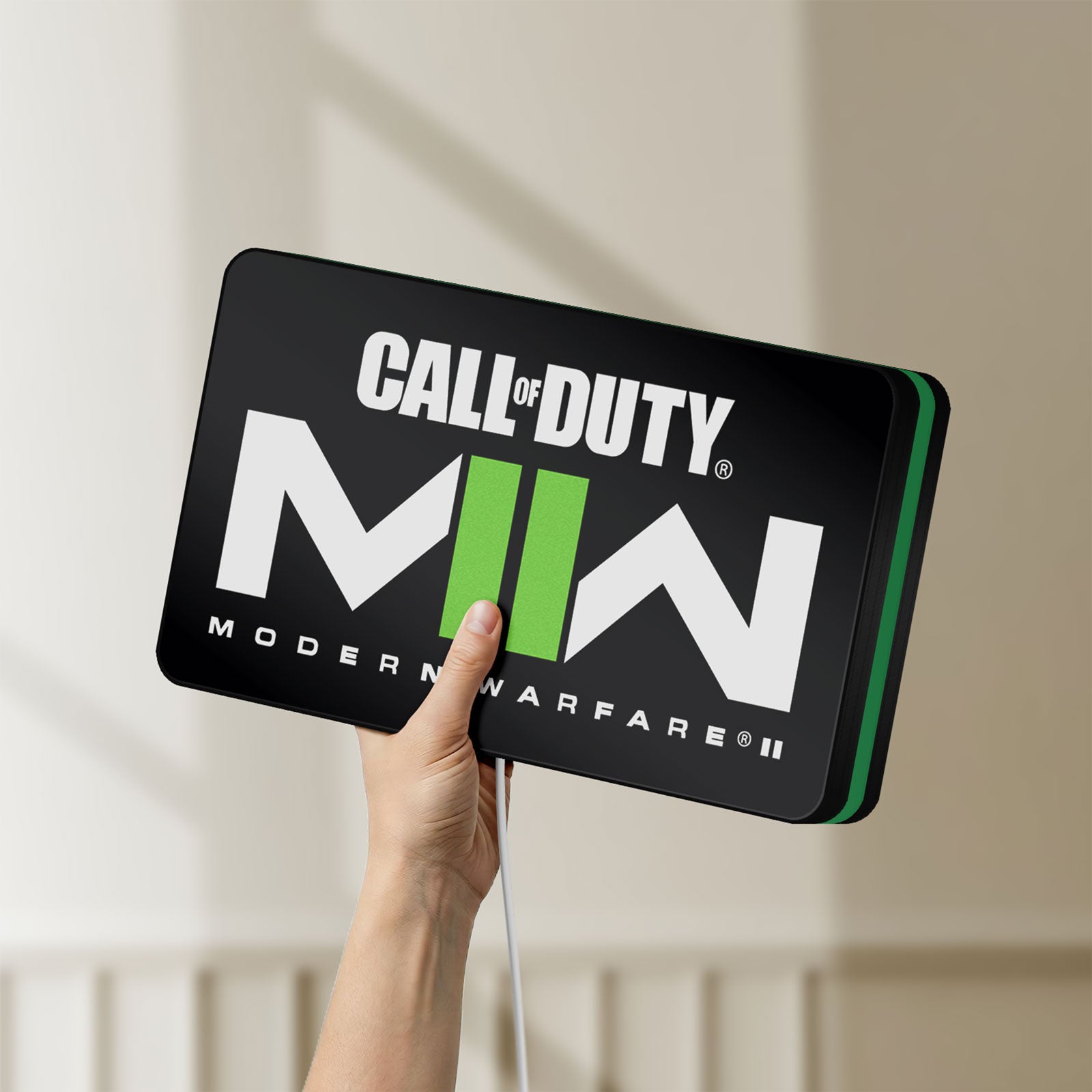 Unlit Call of Duty Modern Warfare II LED lightbox held by hand to show size and details