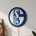 Unlit FC Gelsenkirchen Schalke 04 LED lightbox mounted on a wall in daylight