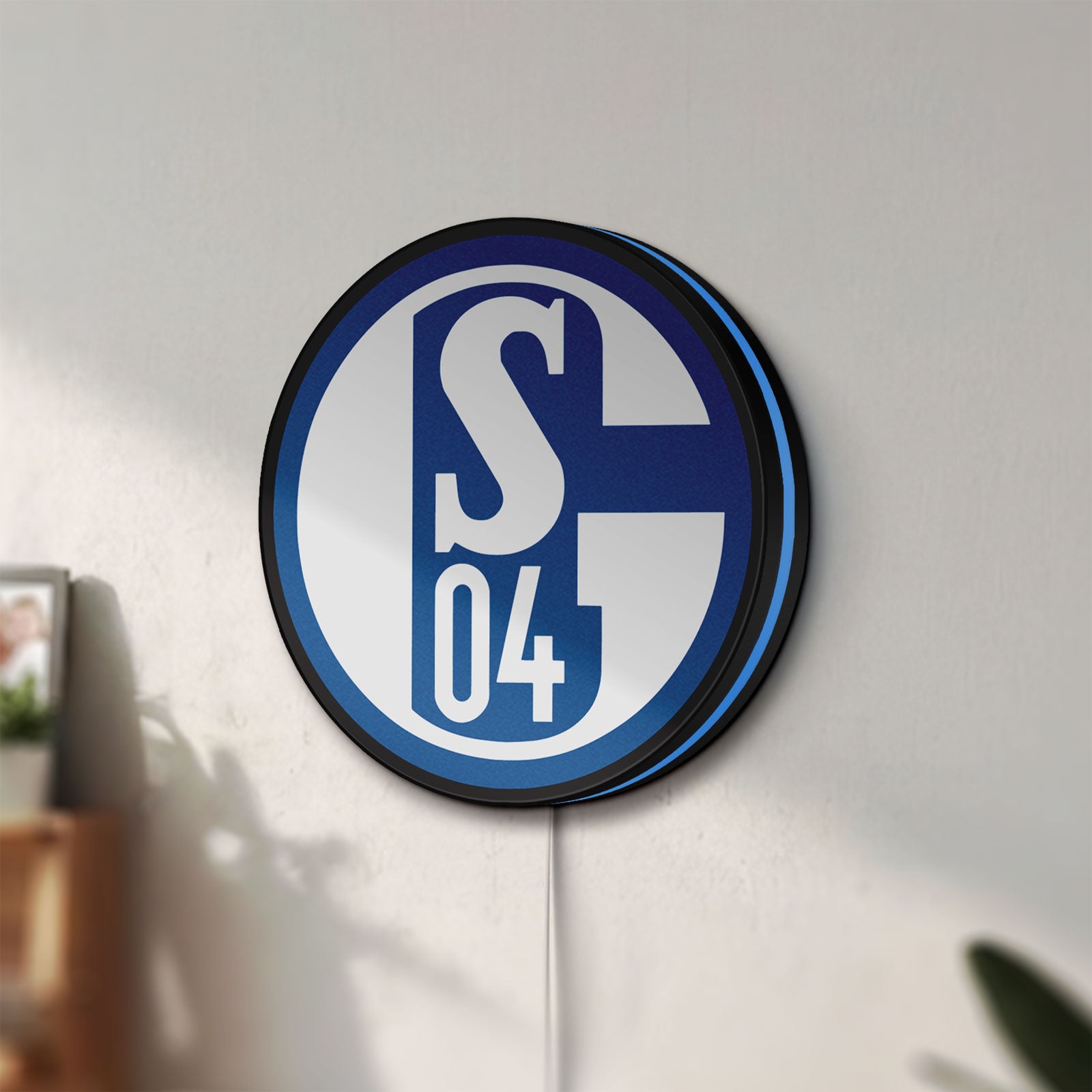 Unlit FC Gelsenkirchen Schalke 04 LED lightbox mounted on a wall in daylight