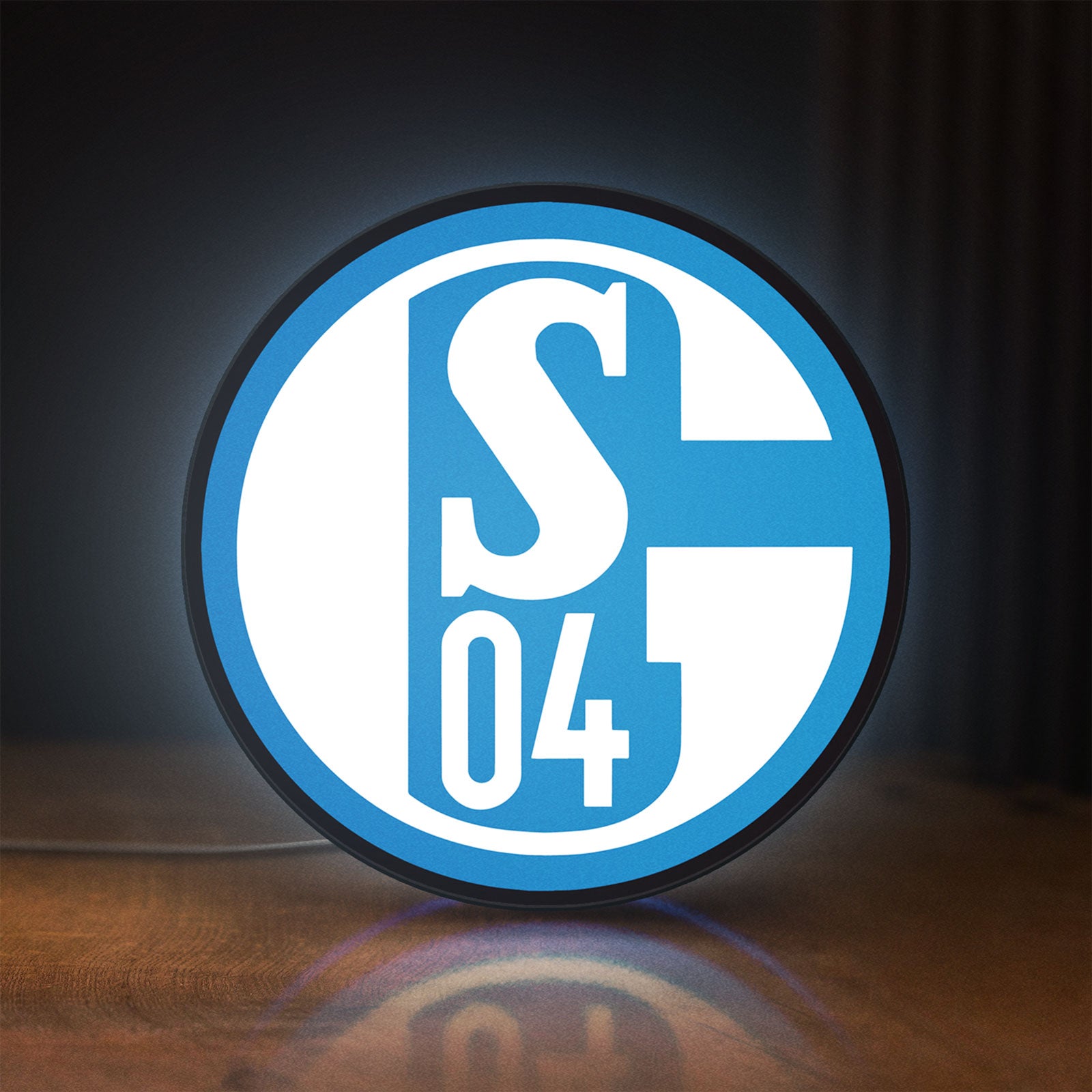 Front view of FC Gelsenkirchen Schalke 04 LED lightbox sign glowing on a wooden desk