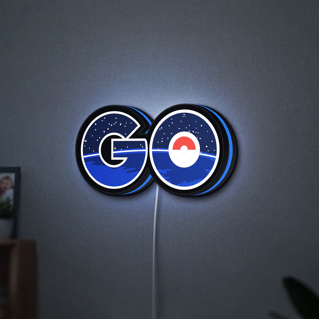 Pokemon Go LED lightbox hanging on a wall with blue glow