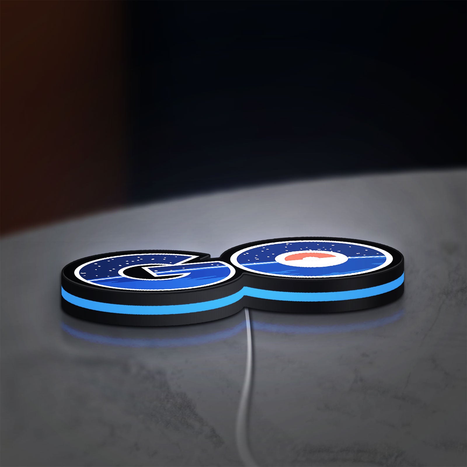 Pokemon Go LED lightbox lying flat on a desk with blue glow