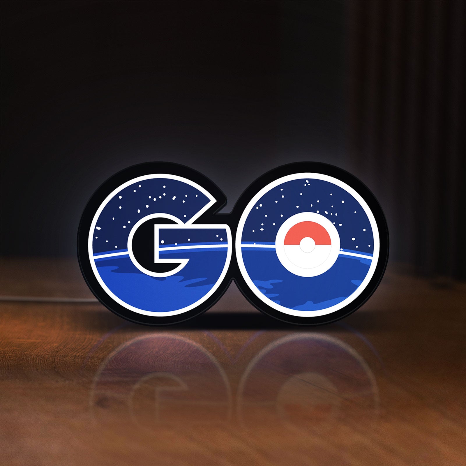 Front view of Pokemon Go LED lightbox sign glowing on a wooden desk