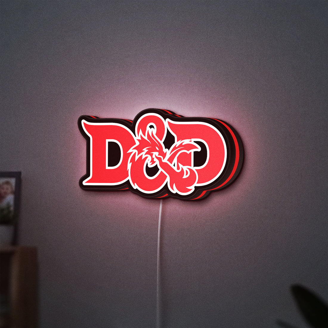 Dungeons Dragons 5e LED lightbox hanging on a wall with red glow