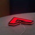 Apex LED lightbox lying flat on a desk with red glow