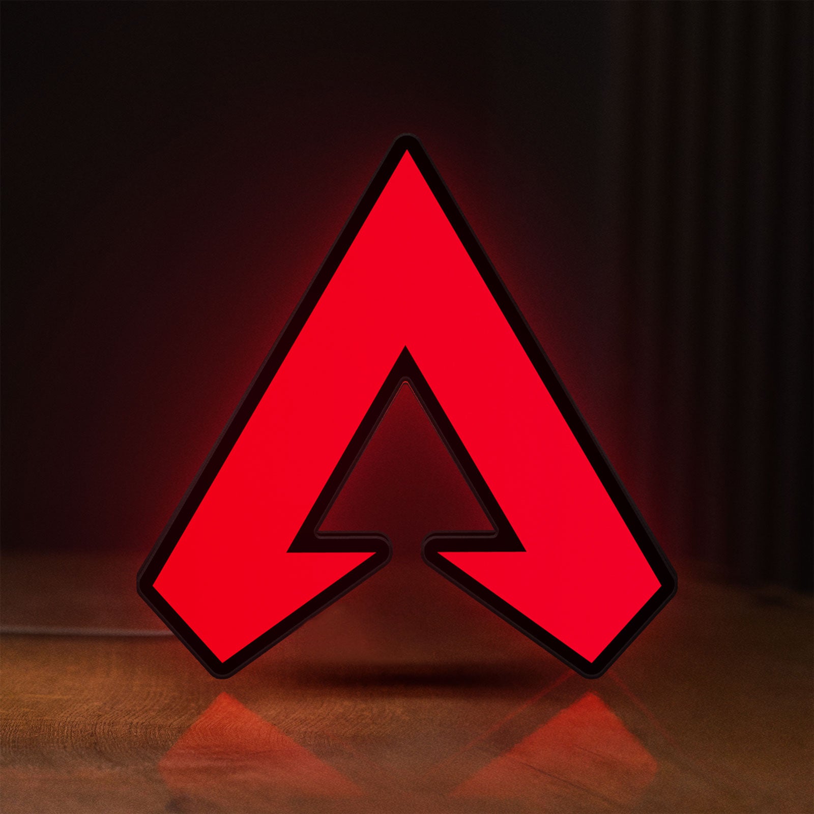 Front view of Apex LED lightbox sign glowing on a wooden desk