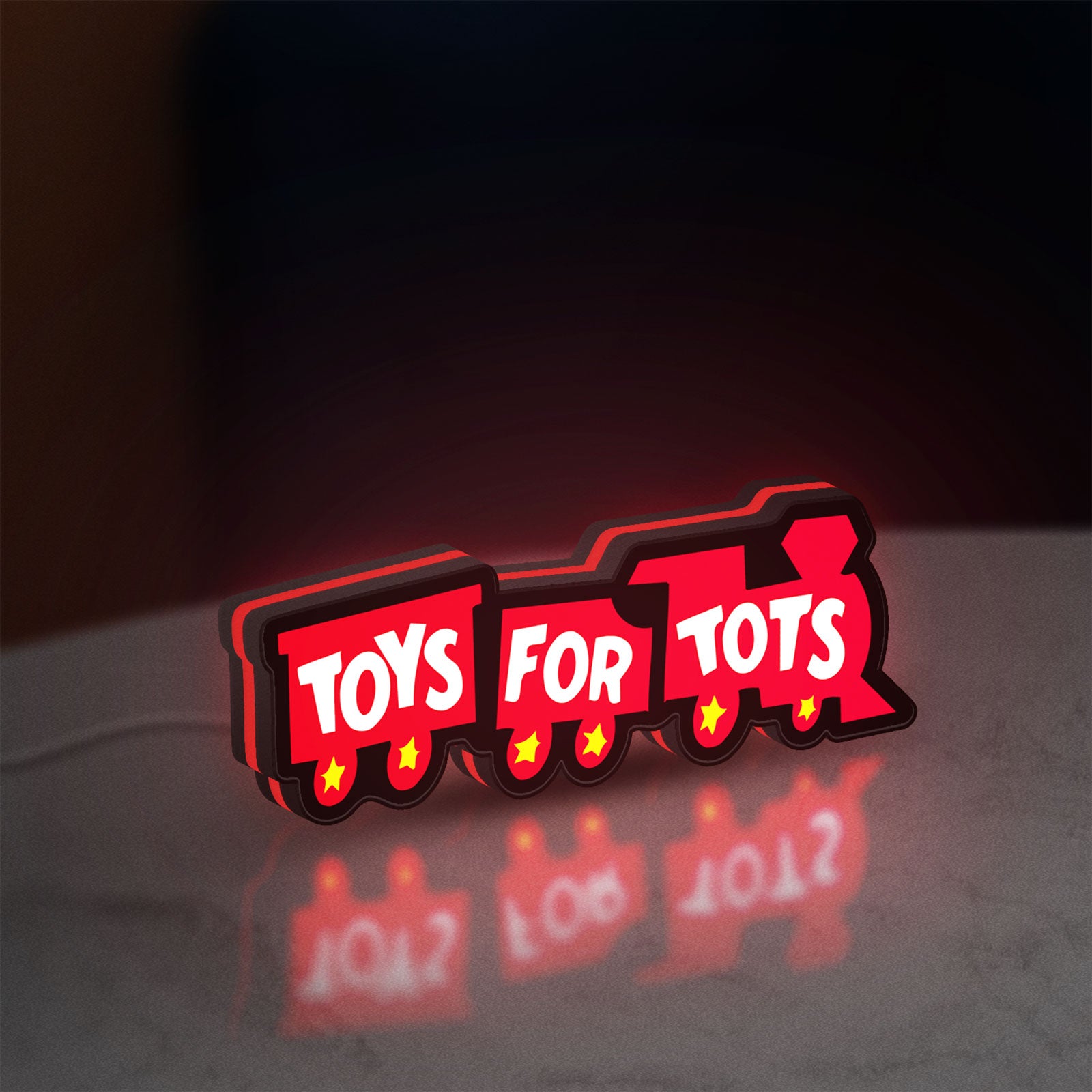Toys For Tots Train LED lightbox standing on a desk from an angled side view with red glow