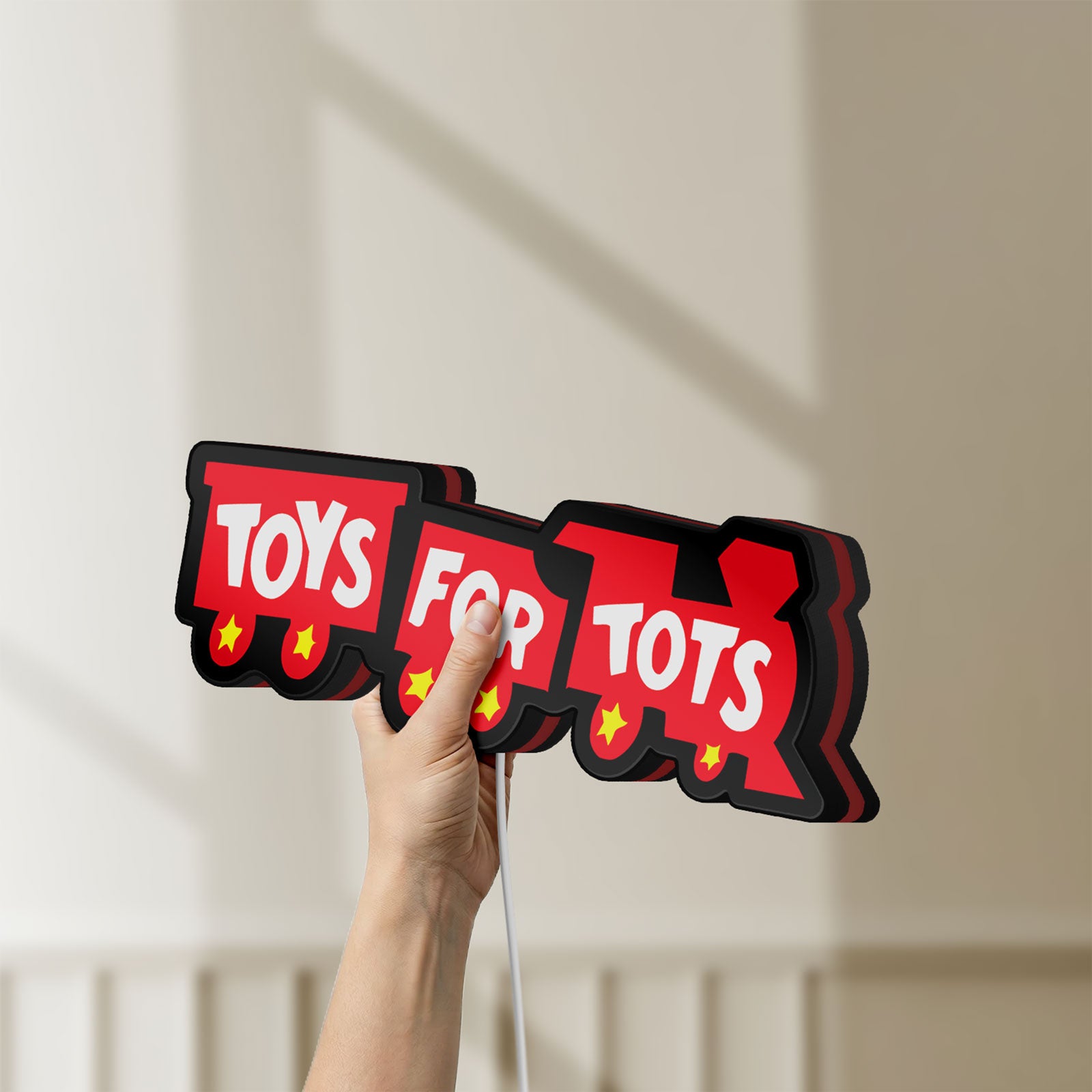 Unlit Toys For Tots Train LED lightbox held by hand to show size and details