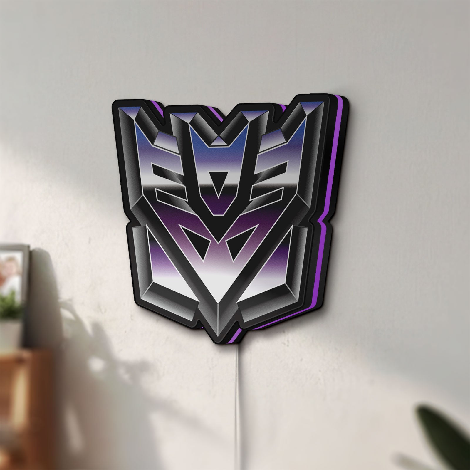 Unlit Decepticon LED lightbox mounted on a wall in daylight