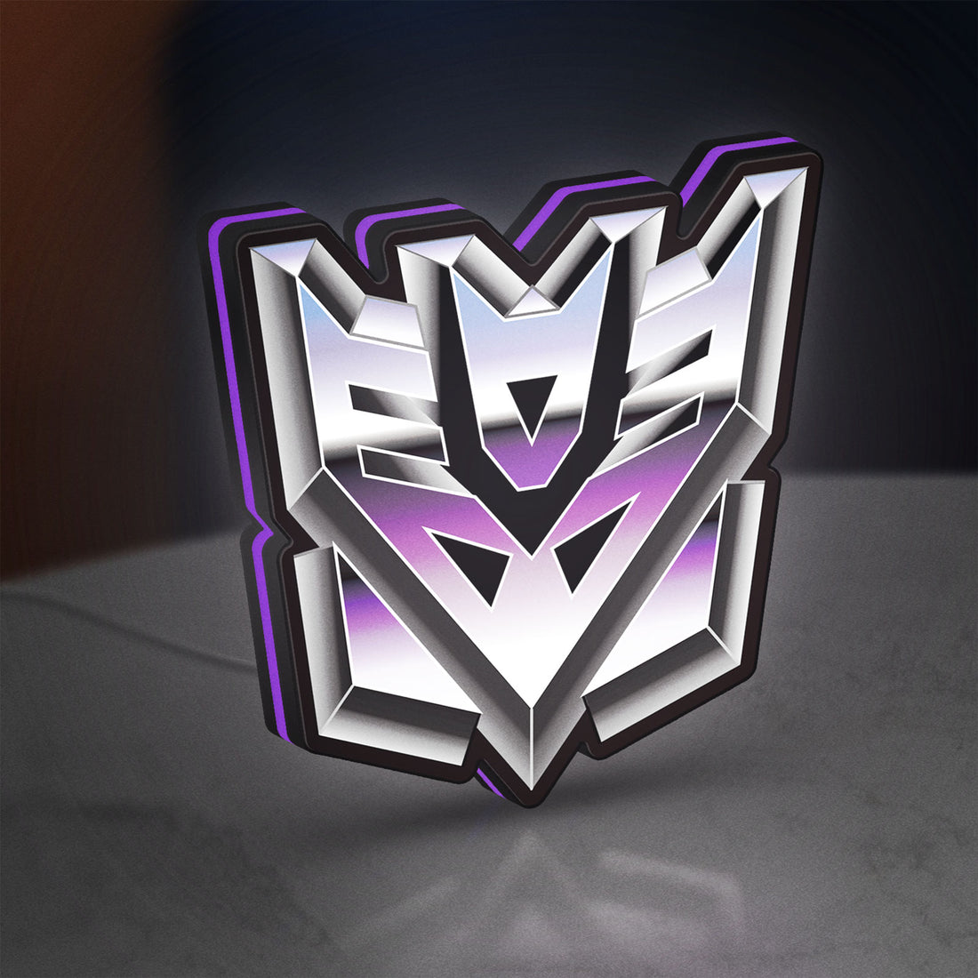Decepticon LED lightbox hanging on a wall with purple glow
