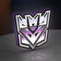 Decepticon LED lightbox standing on a desk from an angled side view with purple glow