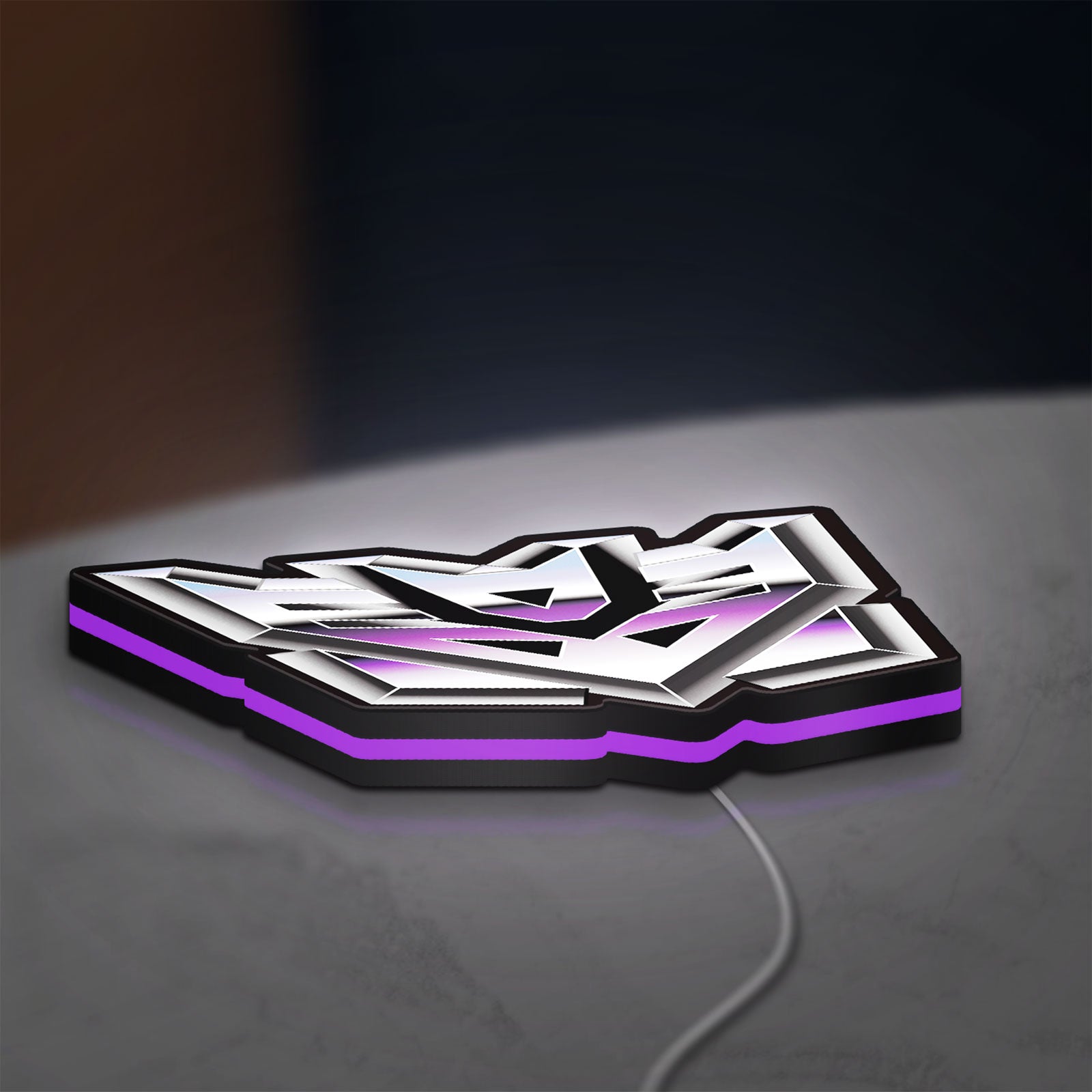 Decepticon LED lightbox lying flat on a desk with purple glow